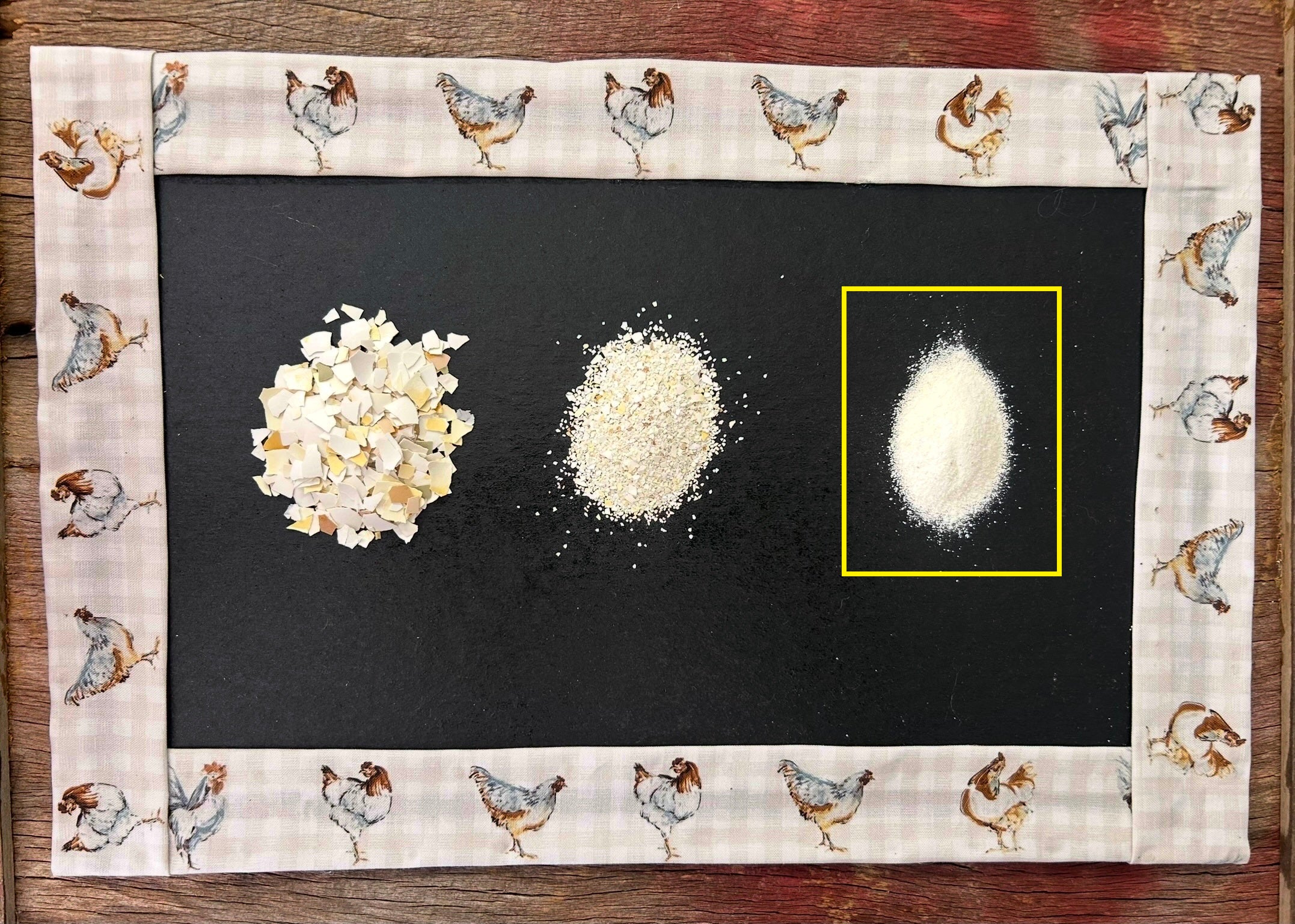 Three eggshell variations on a black surface with a decorative border featuring chicken illustrations